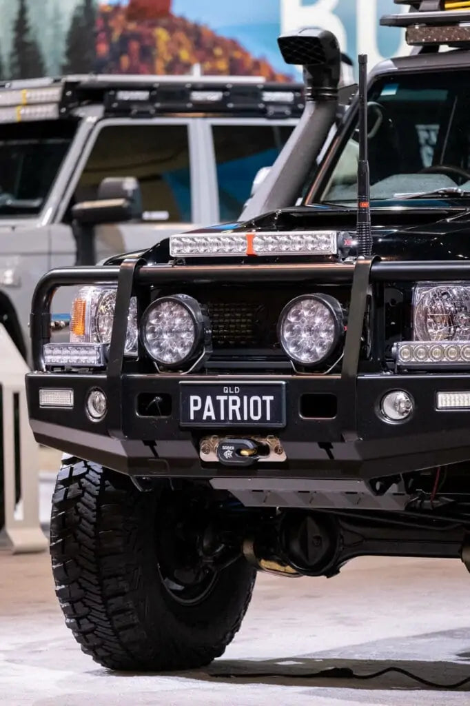 Patriot Games' Black Truck front bumper with driving lights on display at SEMA 2022