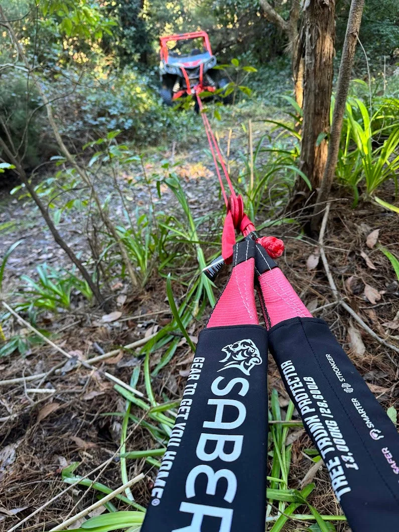 Saber tree trunk protector wrapped around a tree with the winch line running back to a 4WD in the bush
